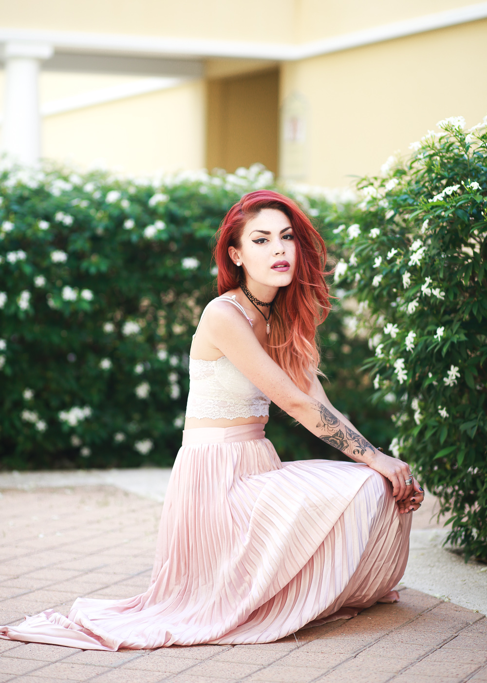 Le Happy wearing pastel pleated skirt and lace bustier
