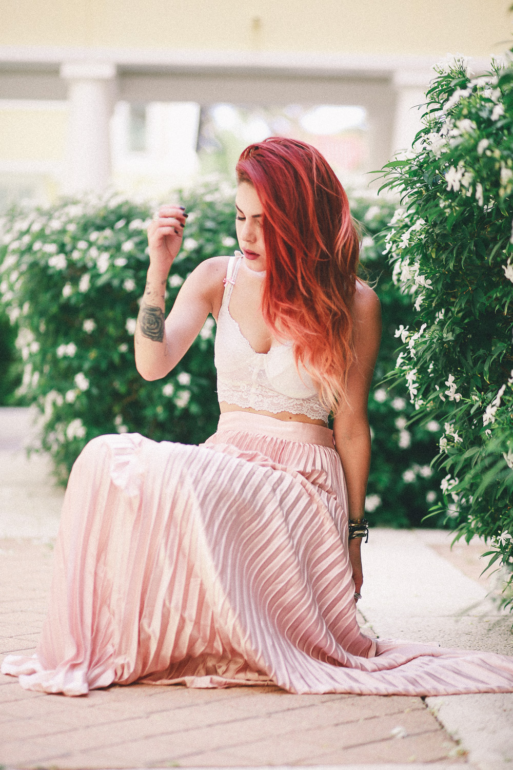 Le Happy wearing pastel pleated skirt and lace bustier