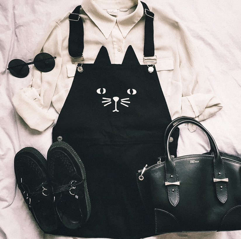 Lay flat of dress overalls with kitty