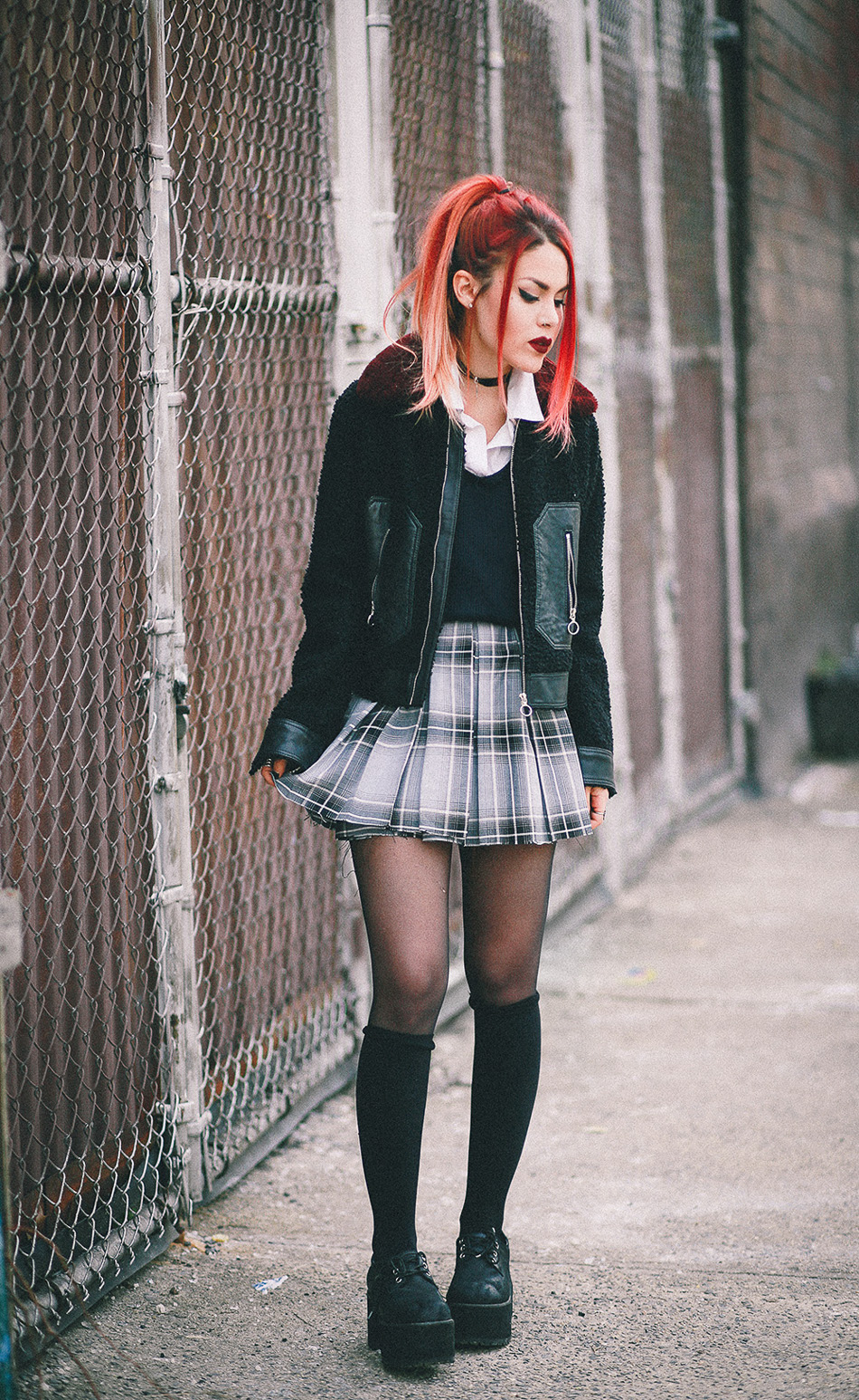 Le Happy wearing Sandro jacket and plaid skirt