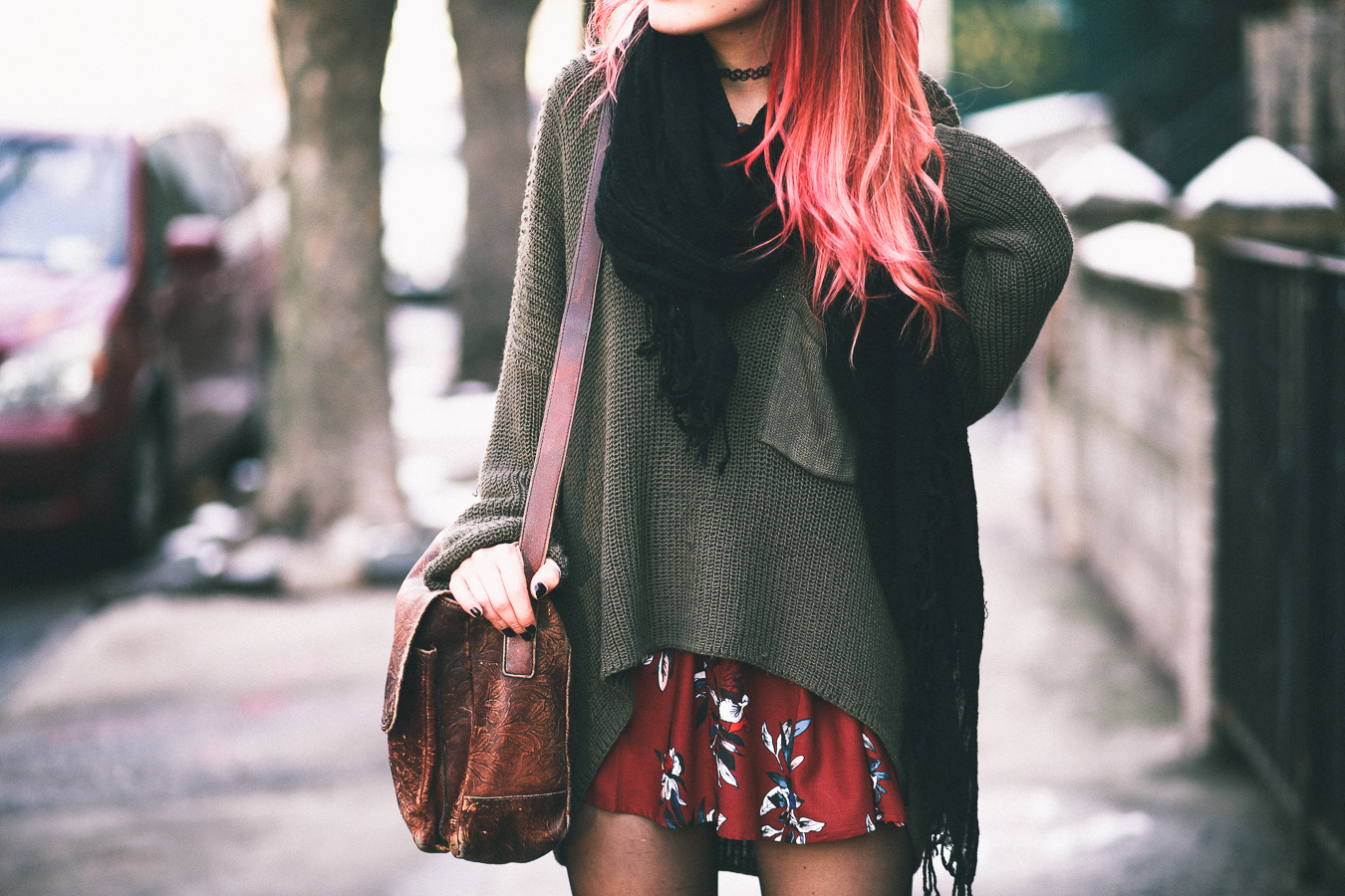 Le Happy wearing chunky green sweater and red floral dress