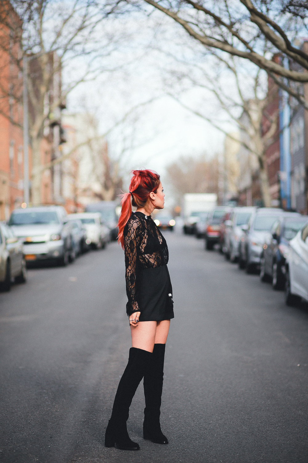 Le Happy wearing Nasty Gal black lace romper and thigh high boots