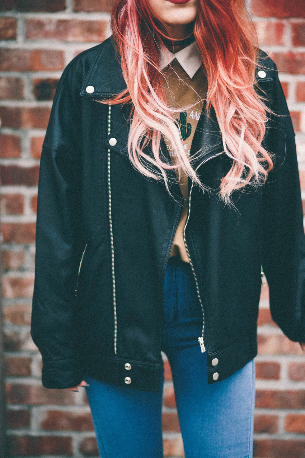 Oversized motorcycle jacket and blue jeans