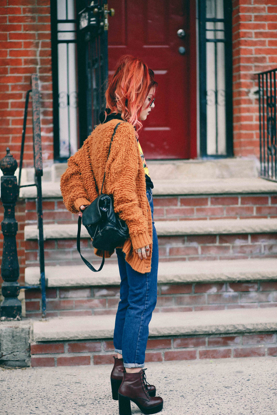 Le Happy wearing chunky sweater and Steve Madden red booties