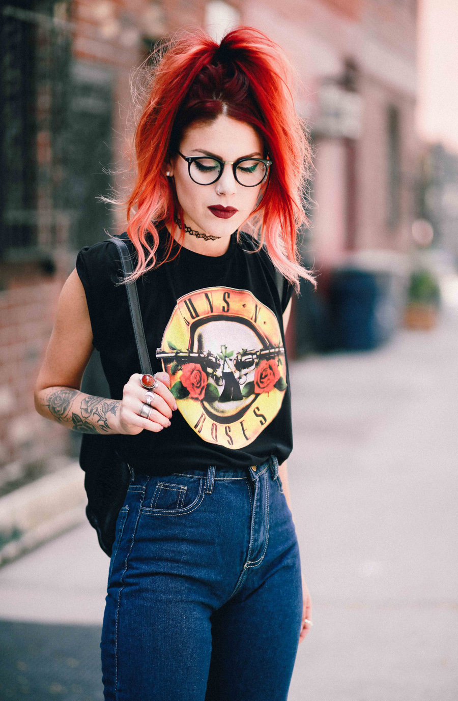 Le Happy wearing high waisted jeans and Guns n Roses tee