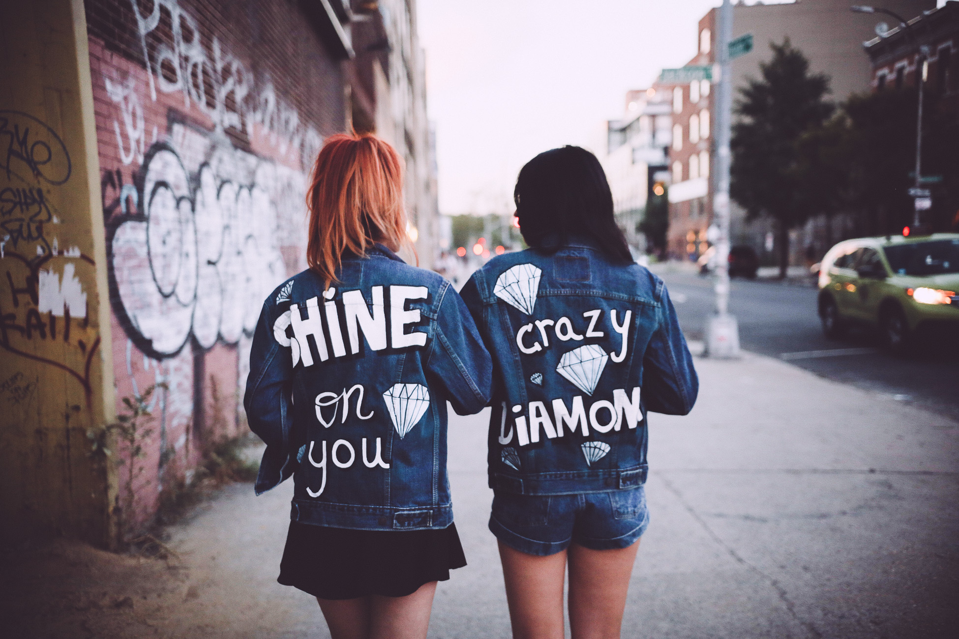 Friends wearing Shop JayDee denim jacket with back art text