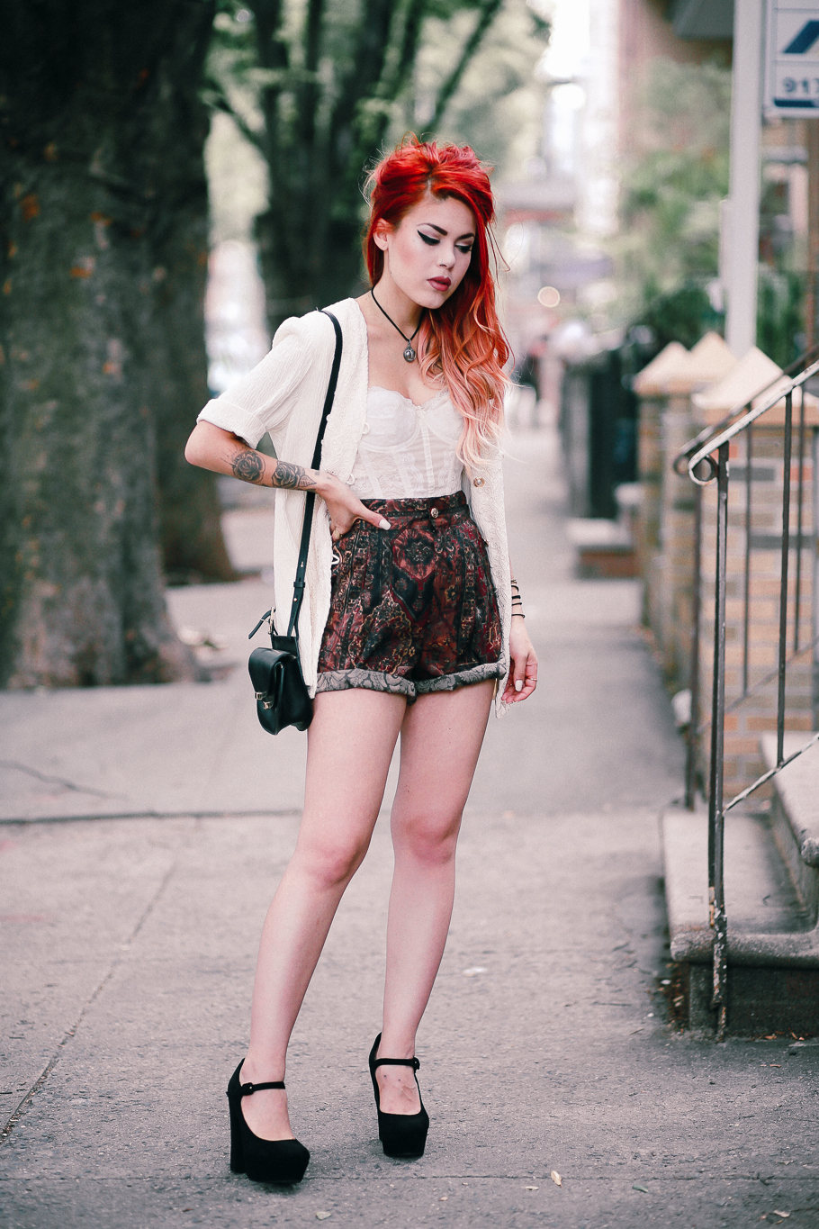 Le Happy wearing vintage shorts and white lace bustier