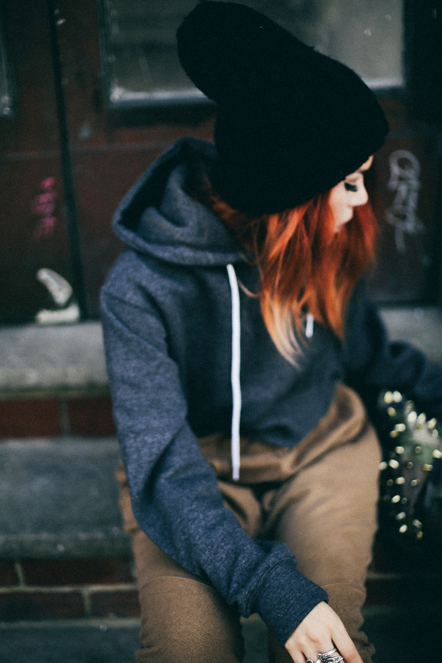 Le Happy wearing cropped hoodie and a beanie