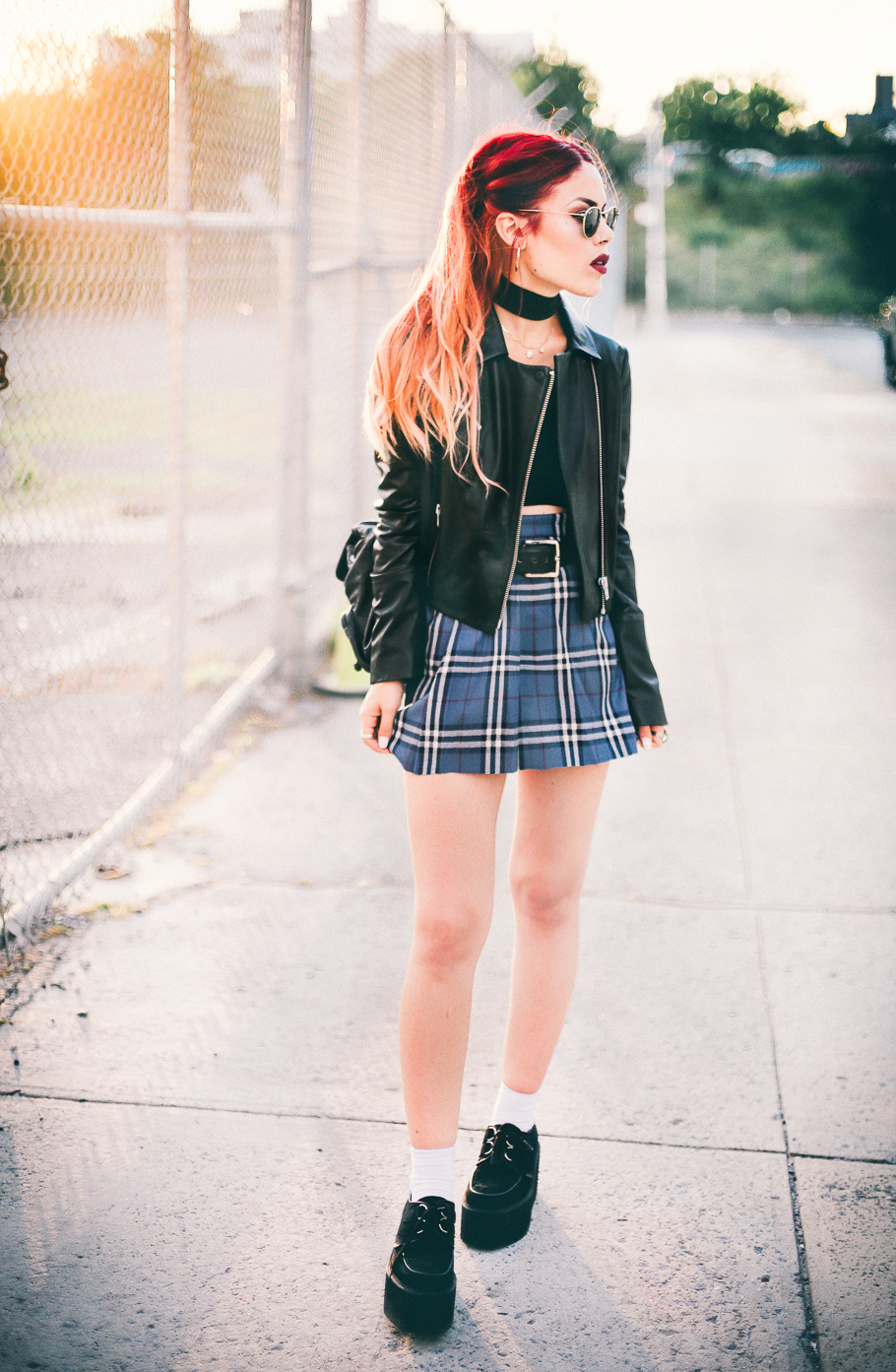 Le Happy wearing creepers with a plaid skirt and Elizabeth and James leather jacket