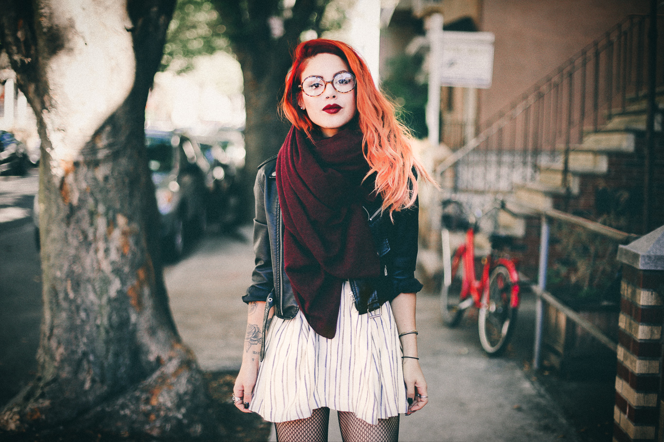 Le Happy wearing Joa striped skater dress and burgundy scarf with a biker jacket